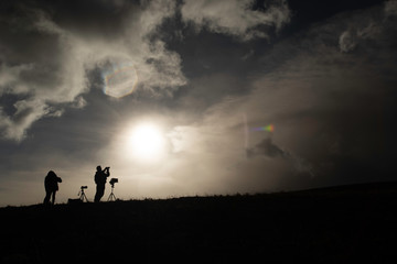 Silhouet of a photographer taking pictures of the Cotopaxi volcano during sunrise