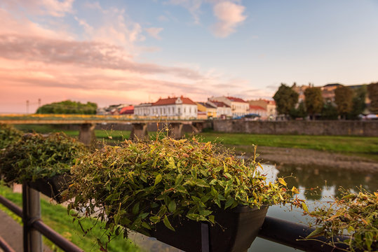 Amazing city view of Uzhhorod at sunset, scenic summer cityscape of old european town on the river Uzh, Zakarpattia, Ukraine, Eastern Europe