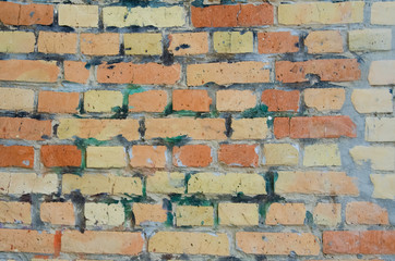 Obraz premium Part of an old red brick wall with cement. Close-up old brick wall texture. Wall of red stones. Masonry with cement. Macro shot of wall.