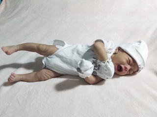 Fototapeta na wymiar A baby lying on the mattress.