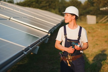 Worker installing solar panels outdoors