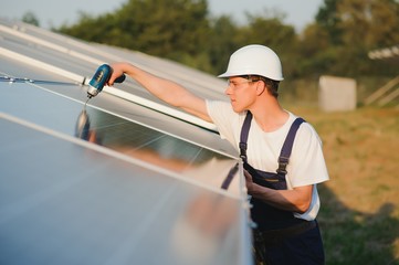 Worker installing solar panels outdoors