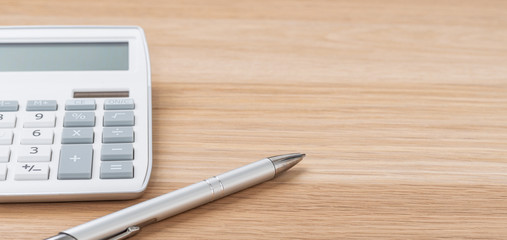 A calculator and a pen with copy space