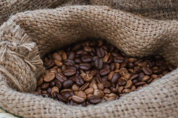 Close up coffee beans are in the bag, out in the outdoors.