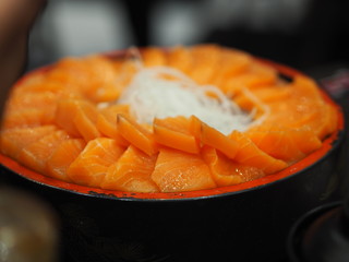 Fresh salmon fish arranged in a wooden tray style Japanese food