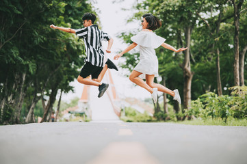 Fototapeta premium Happy smile Asian lesbian couple jumping off the ground outdoor in the park. lgbt concept