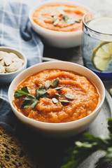 Composition with pumpkin soup on gray background, close up
