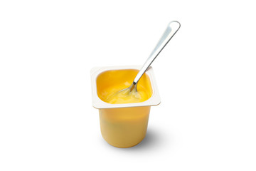 Plastic cup of yogurt and spoon isolated on white background
