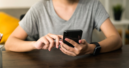 Woman holding a smartphone and using social media on internet.