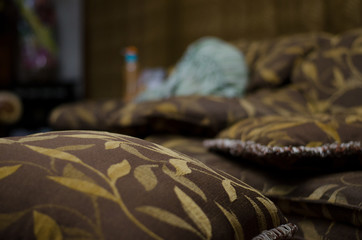 closeup of nice beautiful cozy pillow of luxury soft brown sofa house concept