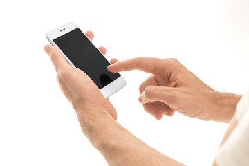 Man holding a smartphone with empty black screen. Mobile phone in a vertical position in hands and isolated on white background. High quality studio shot. Man touching and using phone.