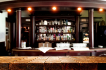 Desk of free space and blurred bar interior. 