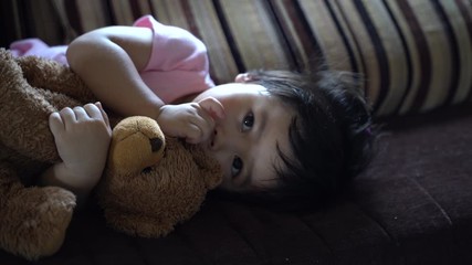 cute baby sucking the fingers and sleep on the sofa