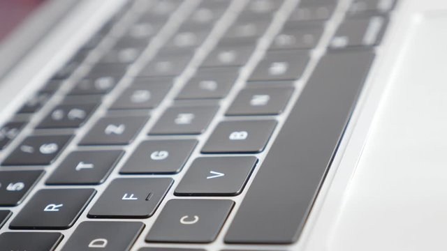 Male finger presses space button on laptop keyboard 4K video