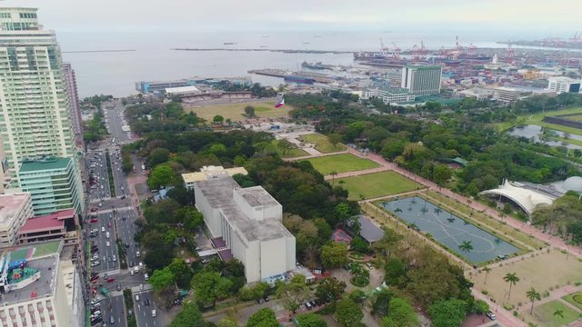 Aerial Approach Shot Of Luneta Park, Facing The Port And Manila Bay