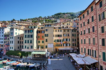 Fototapeta na wymiar Colorful buildings and beach at Camogli on sunny summer day, Liguria, Italy