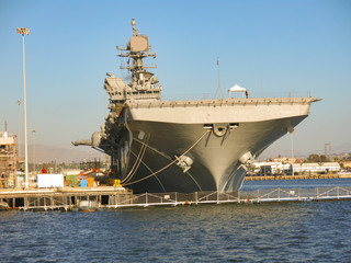 Fototapeta premium Carrier USS in San Diego harbour, USA. Aircraft carrier from front view during sunset time.