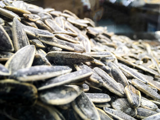 Close up shot of salted sunflower seeds(in TR: Ay cekirdegi) to be cracked for joy in the free time.