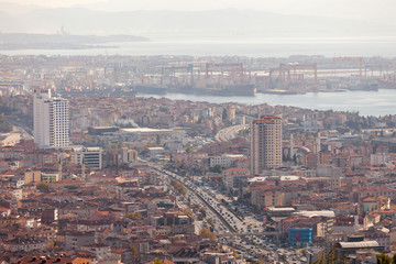 The Tuzla district of Istanbul has a lot of cranes to build ships and the main road of Istanbul is visible and in focus. Istanbul cityscape view from air.