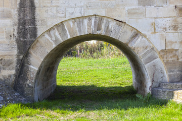 Arch with grass under it. The arch is part of long bridge (in TR: uzunkopru) which is more than 500 years old and is in the list of Unesco. The arch and bridge is built in Ottoman emperor days.