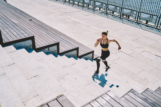 Concentrated Lady Training Running Up Stairs