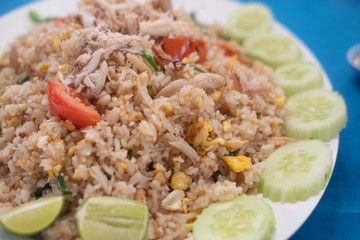 Fried rice with crab decoration with cucumber around plate.