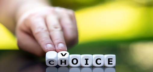 Hand turns dice and changes the word choice to voice.