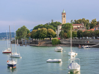 Lesa, beautiful turistic villagge overlooking Lake Maggiore with sailing boats moored in the...