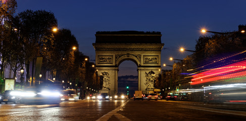 Fototapeta na wymiar Arc de Triomphe, Paris city at night- Arch of Triumph and Champs Elysees with moving cars. Long exposure shot