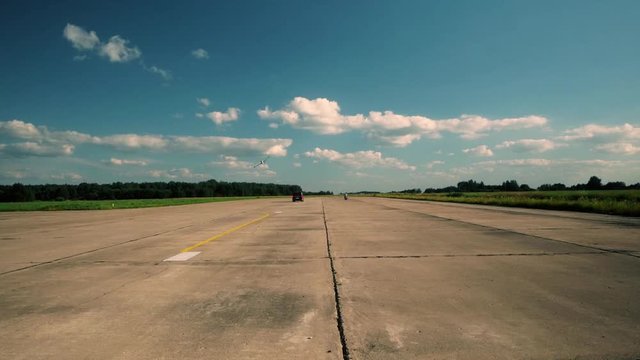 Race plane, motorcycle, car are racing on the runway, sunny weather outside