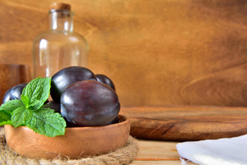Natural organic blue plums in a wooden board