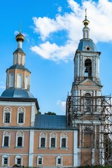Fototapeta premium Russia, Uglich, July 2020. The main building of the church and the bell tower against the blue sky.