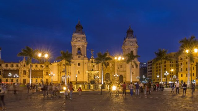 Fountain on The Plaza de Armas day to night transition timelapse, also known as the Plaza Mayor, sits at the heart of Lima's historic center. Illuminated cathedral on a background