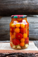 Tomatoes in a glass jar, homemade pickles