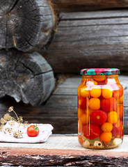 Tomatoes in a glass jar, homemade pickles