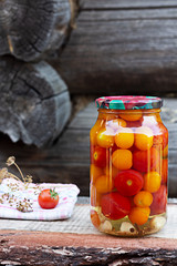 Tomatoes in a glass jar, homemade pickles