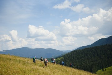 Obraz na płótnie Canvas Group of hikers walking on mountain