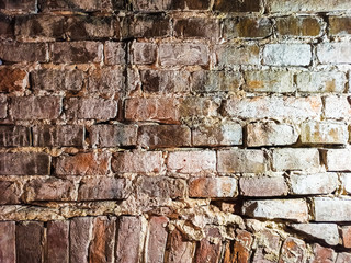 Part of an old red brick wall with cement. Close-up old brick wall texture. Wall of red stones. Antique masonry with cement. Macro shot of wall.