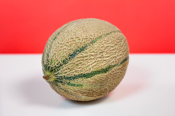 melon cantaloupe on a white and red background.
