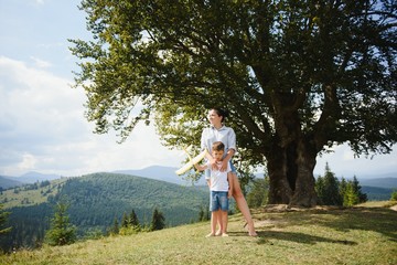 Mother and son having a great time together, traveling in the mountains