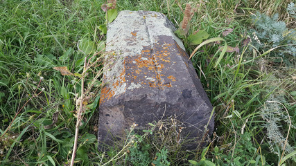 Ancient Armenian cemetery. Christian Grave of 1800. Burial place. Carved tombstone. Very old threaded stones. Memorial to the memory of the old world. Historical memory.
