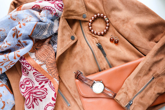 women's fashion and style. women's fashion look. a brown suede jacket, a beautiful scarf, a bag and fashionable women's accessories. flat lay