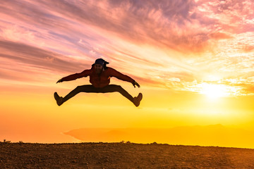 Happy man jumping for joy at sunset. Success, winner, happiness, ttavel concept.