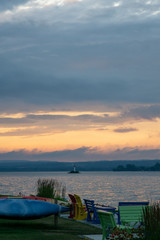 Warm sunset over lighthouse on a reflective blue lake