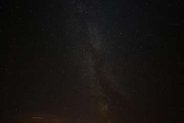 The Perseid meteor shower can be seen in the starry sky