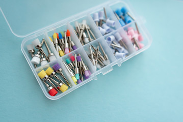 set of dental burs for polishing fillings on a blue background. colored burs of various sizes and shapes. focus on large polishing burs