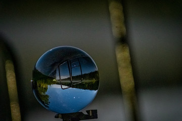 Milkyway captured in a little lensball in front of a lake.