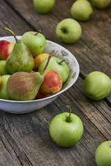 Appels and pears on a wooden background