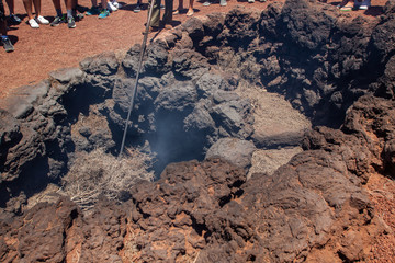 demonstration of fire created by volcano in Timanfaya, Lanzarote