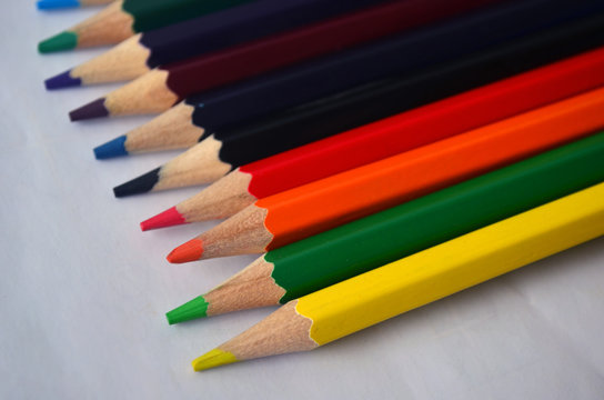 A set of colored pencils for drawing on a white background. Colors, art.